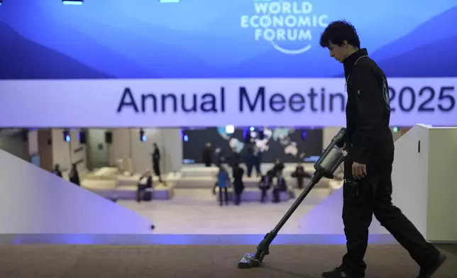 A man cleans the floor at the congress center prior to the official opening of the Annual Meeting of the World Economic Forum in Davos, Switzerland, Monday, Jan. 20, 2025. (AP Photo/Markus Schreiber)