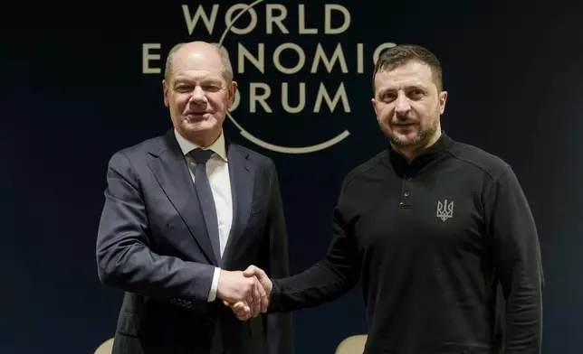 German Chancellor Olaf Scholz, left, and Ukrainian President Volodymyr Zelenskyy meet at the Annual Meeting of World Economic Forum in Davos, Switzerland, Tuesday, Jan. 21, 2025. (AP Photo/Markus Schreiber, Pool)