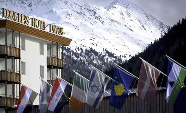 Countries' flags fly on the roof of the congress center in front of Kongress Hotel prior to the 55th annual meeting of the World Economic Forum, WEF, in Davos, Switzerland, Monday, Jan. 20, 2025. (Laurent Gillieron/Keystone via AP)