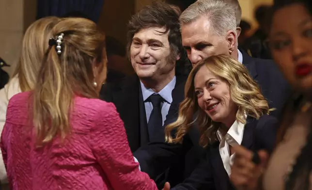 Argentina's President Javier Milei, center, former Speaker of the House Kevin McCarthy, top right, and Italian Premier Giorgia Meloni arrive before the 60th Presidential Inauguration in the Rotunda of the U.S. Capitol in Washington, Monday, Jan. 20, 2025. (Chip Somodevilla/Pool Photo via AP)