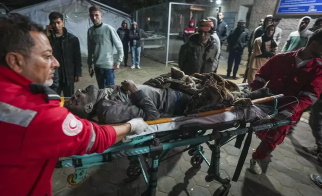 A wounded man is brought to Al-Aqsa Martyrs Hospital following Israeli army airstrikes in the Nuseirat and Maghazi camps, in the central Gaza Strip, Thursday Jan. 2, 2025.(AP Photo/Abdel Kareem Hana)