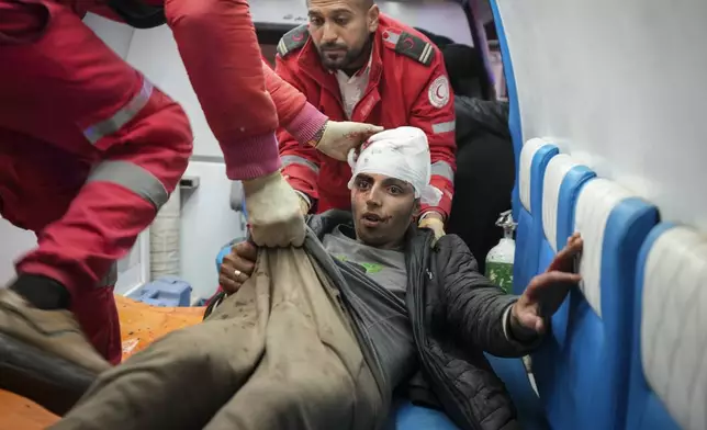 A wounded youth is brought to Al-Aqsa Martyrs Hospital after Israeli army airstrikes targeted the Nuseirat and Maghazi camps in Deir al-Balah, central Gaza Strip, on Thursday, Jan. 2, 2025. (AP Photo/Abdel Kareem Hana)