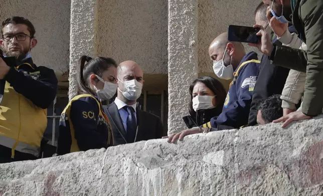 German and French Foreign Affairs ministers Annalena Baerbock, center right, and Jean-Noel Barrot, center left, talk with representatives of the White Helmets during a guided visit to the infamous Saydnaya military prison north of Damascus, Syria, Friday Jan. 3, 2023.(AP Photo/Omar Sanadiki).