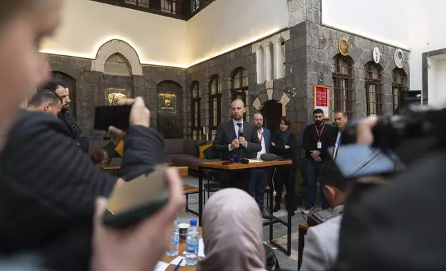 French Foreign Minister Jean-Noel Barrot, center, meets with representatives of civil society during an official visit, in Damascus, Syria, Friday, Jan. 3, 2025. (AP Photo/Mosa'ab Elshamy)