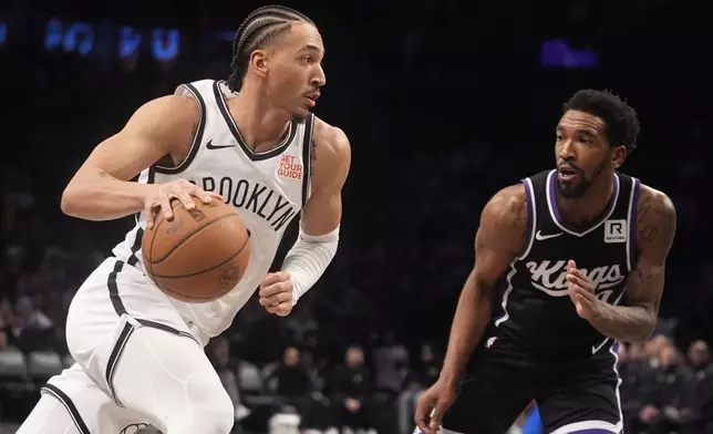 Sacramento Kings' Malik Monk, right, defends Brooklyn Nets' Jalen Wilson during the second half of an NBA basketball game Monday, Jan. 27, 2025, in New York. (AP Photo/Frank Franklin II)