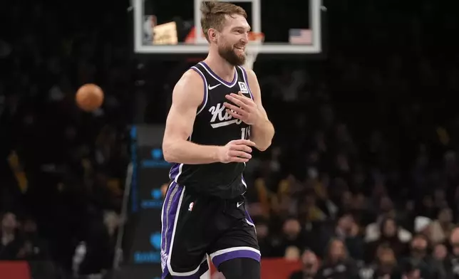 Sacramento Kings' Domantas Sabonis (11) smiles after scoring during the second half of an NBA basketball game against the Brooklyn Nets Monday, Jan. 27, 2025, in New York. (AP Photo/Frank Franklin II)