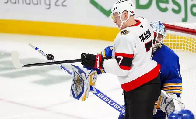 Ottawa Senators' Brady Tkachuk (7) tries to deflect a shot past Buffalo Sabres goalie Ukko-Pekka Luukkonen (1) during third-period NHL hockey game action in Ottawa, Ontario, Thursday, Jan. 9, 2025. (Sean Kilpatrick/The Canadian Press via AP)