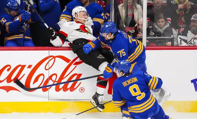 Buffalo Sabres' Connor Clifton (75) hits Ottawa Senators' Brady Tkachuk (7) during first period NHL hockey action in Ottawa on Thursday, Jan. 9, 2025. (Sean Kilpatrick/The Canadian Press via AP)