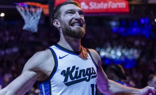 Sacramento Kings center Domantas Sabonis reacts up before an NBA basketball game against the Miami Heat, Monday, Jan. 6, 2025, in Sacramento, Calif. (AP Photo/Sara Nevis)