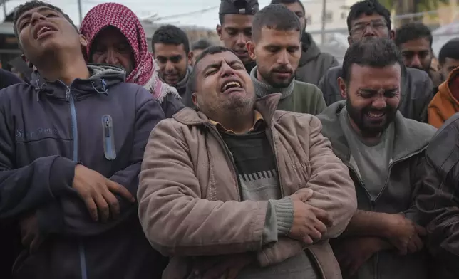 Palestinians mourn their relatives killed in the Israeli bombardment of the Gaza Strip, at Al-Aqsa Martyrs Hospital in Deir al-Balah, Sunday, Jan. 5, 2025. (AP Photo/Abdel Kareem Hana)