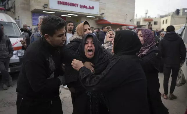 Palestinians mourn their relatives killed in the Israeli bombardment of the Gaza Strip, at Al-Aqsa Martyrs Hospital in Deir al-Balah, Sunday, Jan. 5, 2025. (AP Photo/Abdel Kareem Hana)