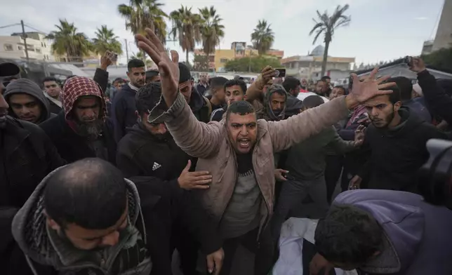 Palestinians mourn their relatives killed in the Israeli bombardment of the Gaza Strip, at Al-Aqsa Martyrs Hospital in Deir al-Balah, Sunday, Jan. 5, 2025. (AP Photo/Abdel Kareem Hana)