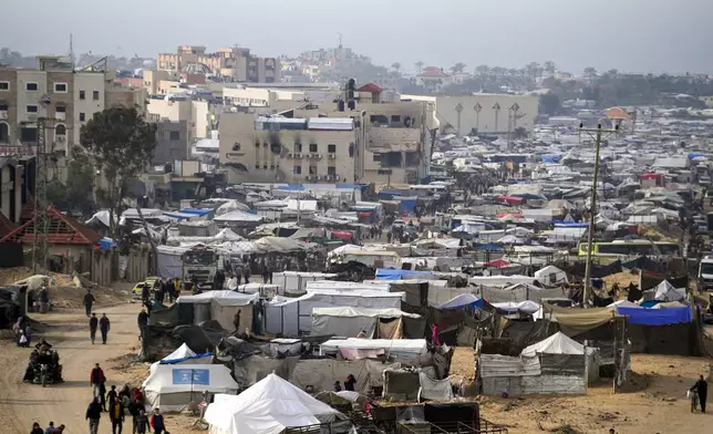 A tent camp for displaced Palestinians is set up amid destroyed buildings in the Khan Younis refugee camp, southern Gaza Strip, Saturday, Jan. 4, 2025. (AP Photo/Abdel Kareem Hana)