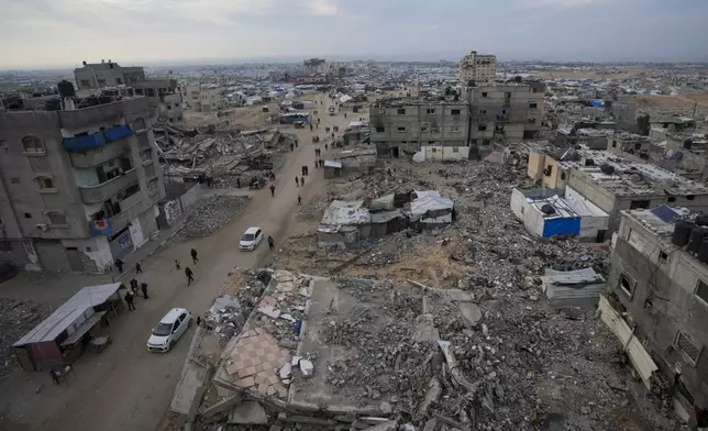 A tent camp for displaced Palestinians is set up amid destroyed buildings in the Khan Younis refugee camp, southern Gaza Strip, Saturday, Jan. 4, 2025. (AP Photo/Abdel Kareem Hana)