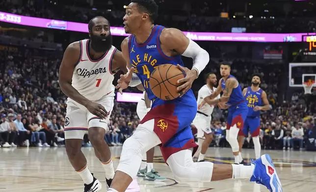 Denver Nuggets guard Russell Westbrook, front, drives to the basket as Los Angeles Clippers guard James Harden defends in the first half of an NBA basketball game Wednesday, Jan. 8, 2025, in Denver. (AP Photo/David Zalubowski)