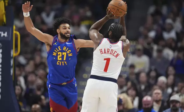 Los Angeles Clippers guard James Harden, right, shoots over Denver Nuggets guard Jamal Murray in the first half of an NBA basketball game Wednesday, Jan. 8, 2025, in Denver. (AP Photo/David Zalubowski)