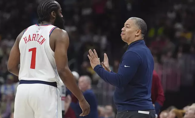 Los Angeles Clippers guard James Harden, left, confers with head coach Tyronn Lue in the first half of an NBA basketball game against the Denver Nuggets, Wednesday, Jan. 8, 2025, in Denver. (AP Photo/David Zalubowski)