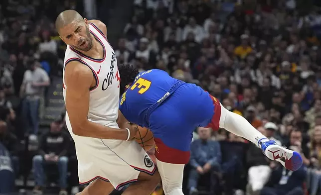 Los Angeles Clippers forward Nicolas Batum, left, reacts as Denver Nuggets guard Julian Strawther collides with Batum while pursuing a loose ball in the first half of an NBA basketball game Wednesday, Jan. 8, 2025, in Denver. (AP Photo/David Zalubowski)