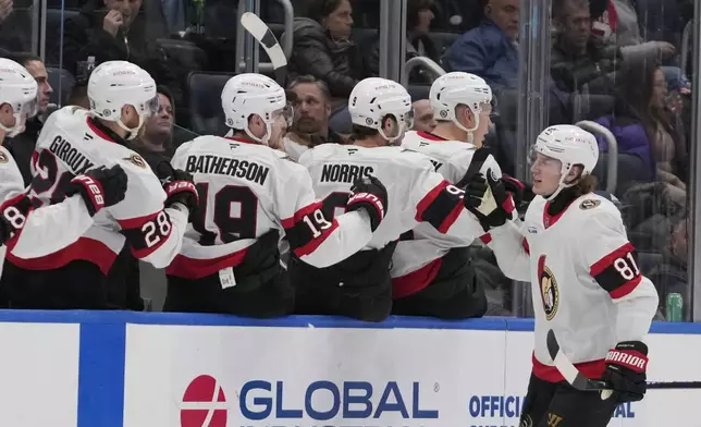 Ottawa Senators' Adam Gaudette (81) celebrates with teammates after scoring a goal during the second period of an NHL hockey game against the New York Islanders, Tuesday, Jan. 14, 2025, in Elmont, N.Y. (AP Photo/Frank Franklin II)