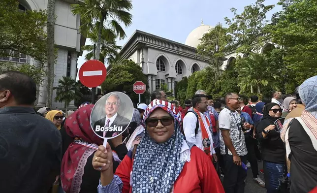 Supporters of former Prime Minister Najib Razak wait outside the Court of Appeals, in Putrajaya, Malaysia, Monday, Jan. 6, 2025, before Najib won an appeal to pursue his bid to serve his remaining corruption sentence under house arrest later Monday. (AP Photo)