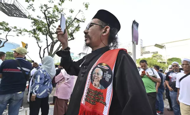 Supporters of former Prime Minister Najib Razak wait outside the Court of Appeals, in Putrajaya, Malaysia, Monday, Jan. 6, 2025, before Najib won an appeal to pursue his bid to serve his remaining corruption sentence under house arrest later Monday. (AP Photo)