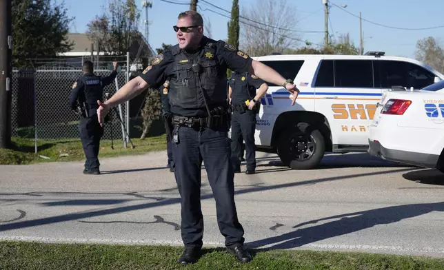 FILE - Harris County Sheriff's officers clear the media from the neighborhood where 42-year-old suspect Shamsud-Din Bahar Jabbar is believed to have lived, Wednesday, Jan. 1, 2025, in Houston. (AP Photo/David J. Phillip, File)