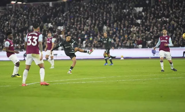 Liverpool's Trent Alexander-Arnold scores his side's fourth goal during the English Premier League soccer match between West Ham United and Liverpool at the London Stadium in London, Sunday, Dec. 29, 2024. (AP Photo/Kirsty Wigglesworth)