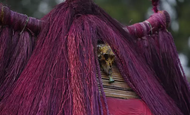 Zangbeto masquerades the traditional Voodoo guardians of the night performing ahead of the annual Voodoo Festival in Ouidah, Benin, Thursday, Jan. 9, 2025. (AP Photo/Sunday Alamba)