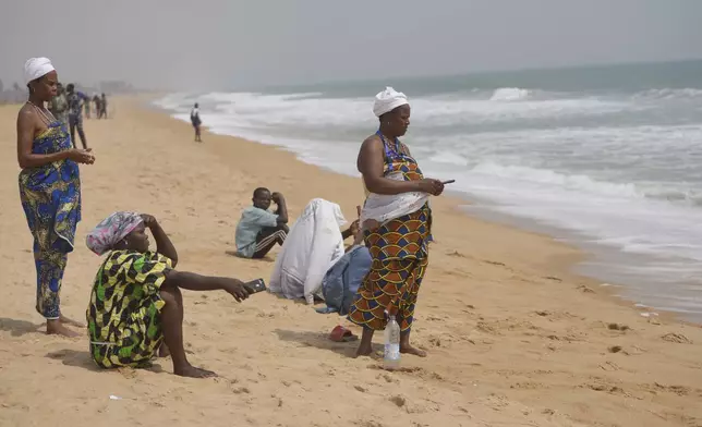 Voodoo worshippers are seen at the beach in Ouidah, Benin, Saturday, Jan. 11, 2025. (AP Photo/Sunday Alamba)