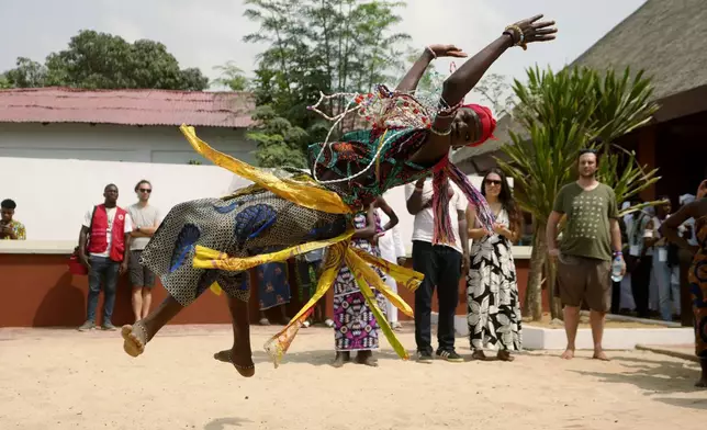 A Voodoo worshipper dances during the annual Voodoo Festival in Ouidah, Benin, Friday, Jan. 10, 2025. (AP Photo/Sunday Alamba)