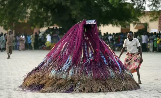 Zangbeto masquerade the traditional Voodoo guardians of the night performing ahead of the annual Voodoo Festival in Ouidah, Benin, Thursday, Jan. 9, 2025. (AP Photo/Sunday Alamba)