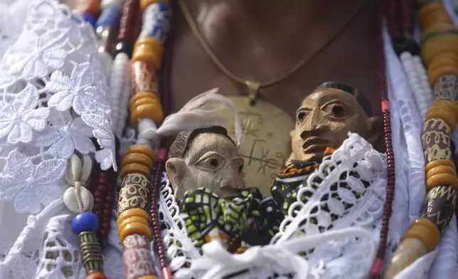 Voodoo dolls are seen wrapped into a woman's dress, during the annual Voodoo Festival in Ouidah, Benin, Friday, Jan. 10, 2025. (AP Photo/Sunday Alamba)