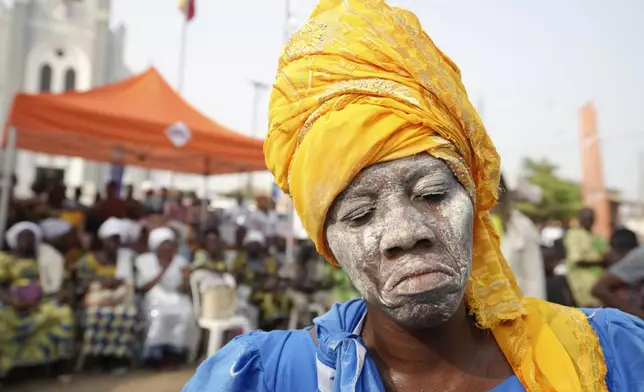 A voodoo worshipper dances ahead of the annual Voodoo Festival in Ouidah, Benin, Thursday, Jan. 9, 2025. (AP Photo/Sunday Alamba)