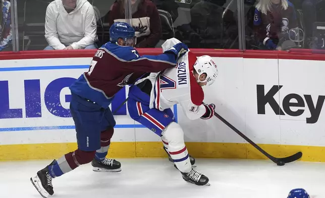 Colorado Avalanche defenseman Devon Toews, left, checks Montreal Canadiens center Nick Suzuki in the second period of an NHL hockey game Saturday, Jan. 4, 2025, in Denver. (AP Photo/David Zalubowski)