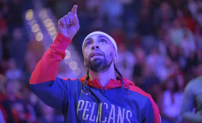 New Orleans Pelicans guard Jose Alvarado gestures after a moment of silence honoring the victims of the New Year's Day deadly attack on Bourbon Street before an NBA basketball game against the Washington Wizards in New Orleans, Friday, Jan. 3, 2025. (AP Photo/Matthew Hinton)