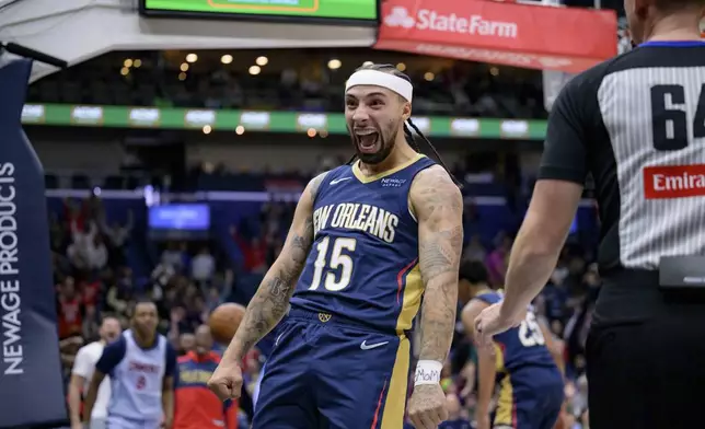 New Orleans Pelicans guard Jose Alvarado (15) reacts after passing to Pelicans guard Trey Murphy III (25) for a dunk against the Washington Wizards during the first half of an NBA basketball game in New Orleans, Friday, Jan. 3, 2025. (AP Photo/Matthew Hinton)