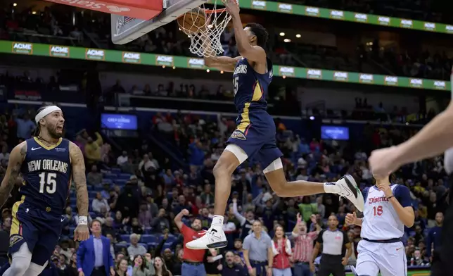 New Orleans Pelicans guard Jose Alvarado (15) reacts after passing to New Orleans Pelicans guard Trey Murphy III, top center, for a dunk against the Washington Wizards during the first half of an NBA basketball game in New Orleans, Friday, Jan. 3, 2025. (AP Photo/Matthew Hinton)