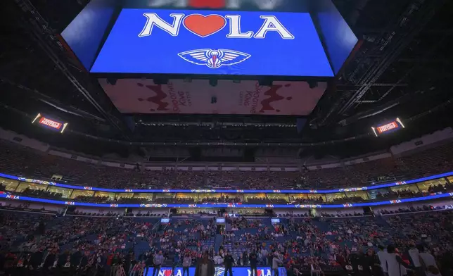 A sign is displayed in honor of the victims of the New Year's Day deadly attack on Bourbon Street before an NBA basketball game between the New Orleans Pelicans and the Washington Wizards in New Orleans, Friday, Jan. 3, 2025. (AP Photo/Matthew Hinton)