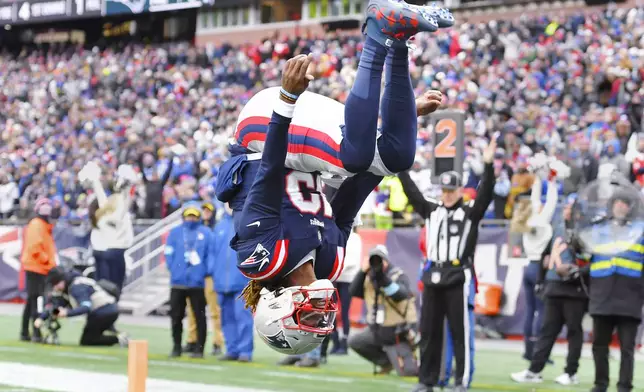 New England Patriots quarterback Joe Milton III (19) flips while celebrating after his touchdown against the Buffalo Bills during the first half of an NFL football game, Sunday, Jan. 5, 2025, in Foxborough, Mass. (AP Photo/Steven Senne)