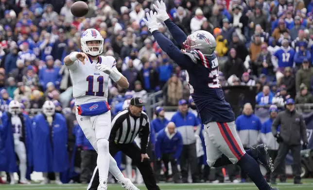 Buffalo Bills quarterback Mitchell Trubisky (11) throws a pass while pressured by New England Patriots linebacker Anfernee Jennings (33) during the first half of an NFL football game, Sunday, Jan. 5, 2025, in Foxborough, Mass. (AP Photo/Robert F. Bukaty)