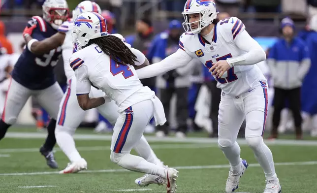 Buffalo Bills quarterback Josh Allen (17) hands off to running back James Cook (4) during the first half of an NFL football game against the New England Patriots, Sunday, Jan. 5, 2025, in Foxborough, Mass. (AP Photo/Robert F. Bukaty)