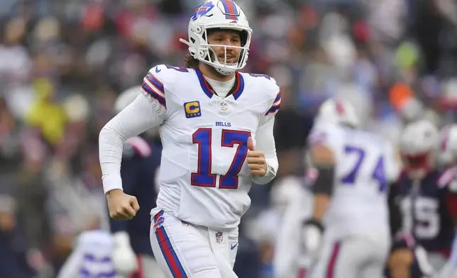 Buffalo Bills quarterback Josh Allen (17) smiles while coming out of the game during the first half of an NFL football game against the New England Patriots, Sunday, Jan. 5, 2025, in Foxborough, Mass. (AP Photo/Steven Senne)