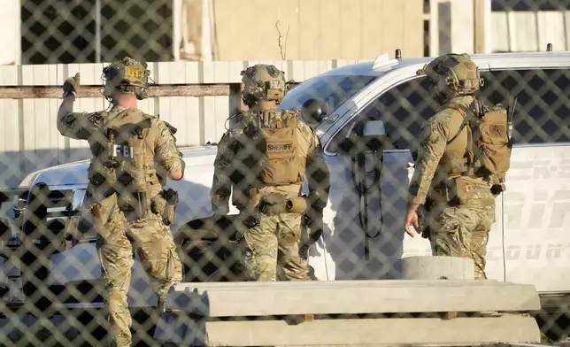 FILE - FBI and Harris County Sheriff's SWAT members work, Wednesday, Jan. 1, 2025, near Crescent Peak Drive in Houston, where a police investigation continues into a property associated with Shamsud-Din Jabbar, who has been identified as the attacker in the New Orleans massacre. (Melissa Phillip/Houston Chronicle via AP, File)