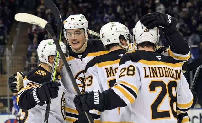 From left, Boston Bruins' Brad Marchand, Nikita Zadorov, Charlie McAvoy, David Pastrnak and Elias Lindholm celebrate after Lindholm scored during the second period of an NHL hockey game against the New York Rangers, Thursday, Jan. 2, 2025, in New York. (AP Photo/Pamela Smith)