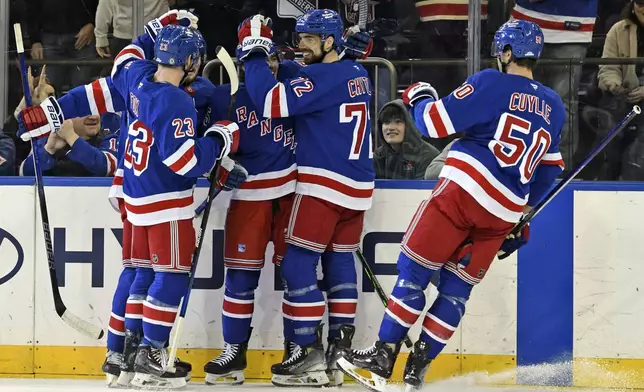 New York Rangers' from left, Ryan Lindgren, Adam Fox, Brett Berard, Filip Chytil and Will Cuylle celebrate after Berard scored during the first period of an NHL hockey game against the Boston Bruins, Thursday, Jan. 2, 2025, in New York. (AP Photo/Pamela Smith)