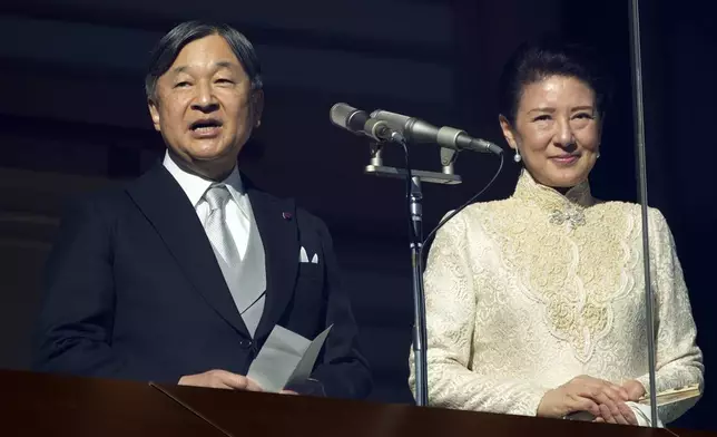 Japan's Emperor Naruhito delivers a speech as Empress Masako stands next to him during a public appearance for the new year's celebrations with their imperial families at the Imperial Palace, Thursday, Jan. 2, 2025, in Tokyo. (AP Photo/Eugene Hoshiko, Pool)