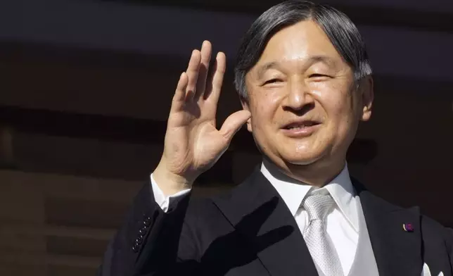 Japan's Emperor Naruhito waves to well-wishers from the balcony during a public appearance for the new year's celebrations with his imperial families at Imperial Palace, Thursday, Jan. 2, 2025, in Tokyo. (AP Photo/Eugene Hoshiko, Pool)