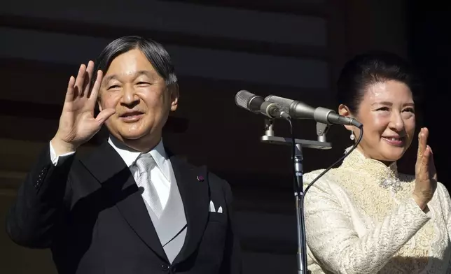 Japan's Emperor Naruhito waves with Empress Masako to well-wishers from the balcony during a public appearance for New Year's Day with his imperial families at Imperial Palace, Thursday, Jan. 2, 2025, in Tokyo. (AP Photo/Eugene Hoshiko, Pool)