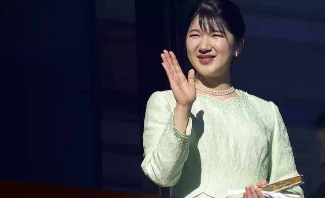 Japan's Princess Aiko waves at well-wishers from the balcony during a public appearance for the new year's celebrations with her imperial families at the Imperial Palace, Thursday, Jan. 2, 2025, in Tokyo. (AP Photo/Eugene Hoshiko, Pool)