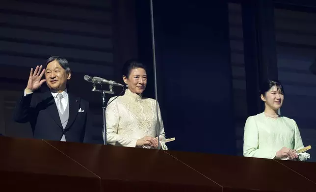 Japan's Emperor Naruhito, from left, waves with Empress Masako and Princess Aiko to well-wishers from the balcony during a public appearance for the new year's celebrations with his imperial families at Imperial Palace, Thursday, Jan. 2, 2025, in Tokyo. (AP Photo/Eugene Hoshiko, Pool)